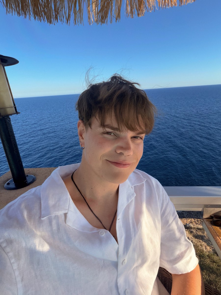 Justin smiling by the water